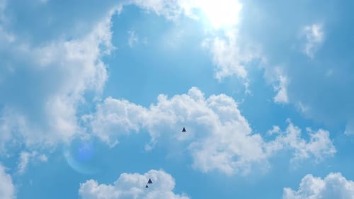 Abstract Geometric Shapes Flying Through Bright Sunny Sky