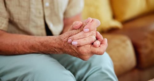 Senior Adult Resting Interlocked Fingers at Home