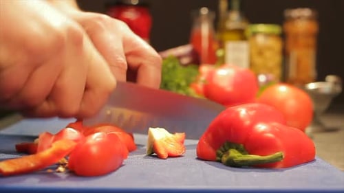 Hands Slicing Red Bell Pepper for Cooking