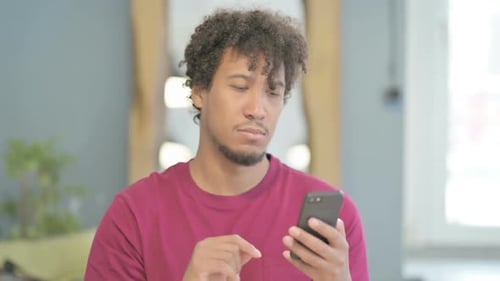 Young Adult Using Smartphone Indoors