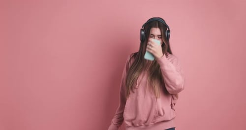 Young Woman Listening to Music and Dancing