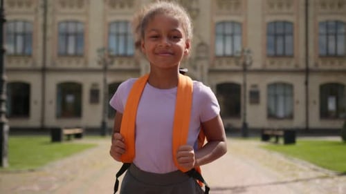 Cheerful Girl Running to School with Backpack