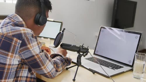 Man Recording Audio With Microphone Indoors