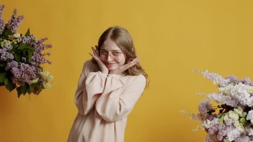 Pretty Girl Posing with Lilac Flowers in Studio