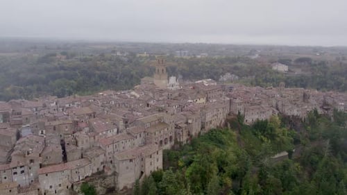 Aerial view of medieval village with cathedral on cliff, Italy.