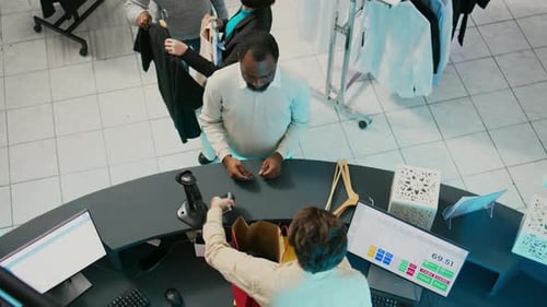 Customers Making Purchases at Store Service Counter