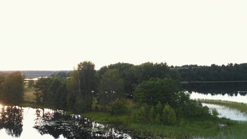 Drone Rising Above Small Picturesque Island on Incredible Large Still Lakes and Calm Green Summer
