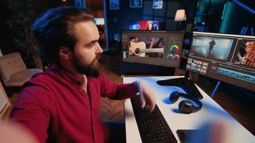 Man Explaining Video Editing Process at Computer