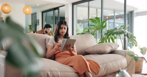 Typing, search and tablet with woman on sofa for social media post, reading or online update