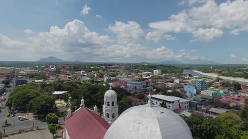 flying up over a Basilica Church tower, A landscape view of the city.