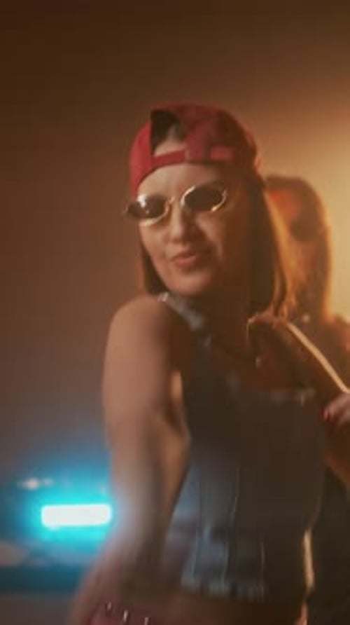 Vertical of Lady in Retro Outfit Rocking out to Music in Club