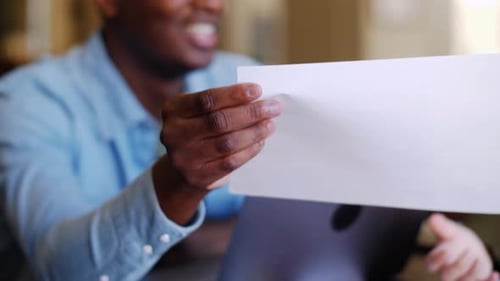 Man reviewing documents in an office environment.