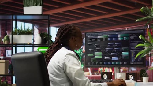 Woman Works at Computer in Modern Office Space