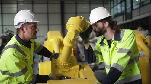 Engineer work at robotic arm factory.