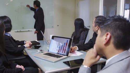 Business Meeting with Chart Presentation in Conference Room