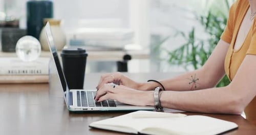 4k video footage of an unrecognisable businesswoman using a laptop in a modern office