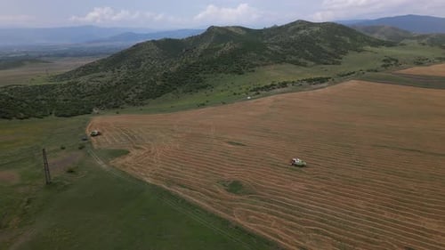 Combaine Works In Crop Fields In Mountains
