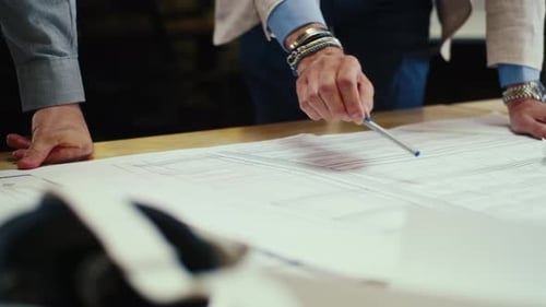 Engineers Studying Blueprint in Office