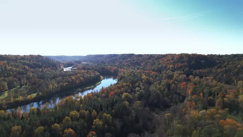 Autumn foliage along a winding river in a tranquil landscape