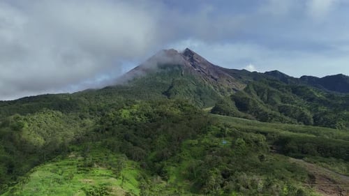 Merapi Volcano Peaks with Early Morning Clouds