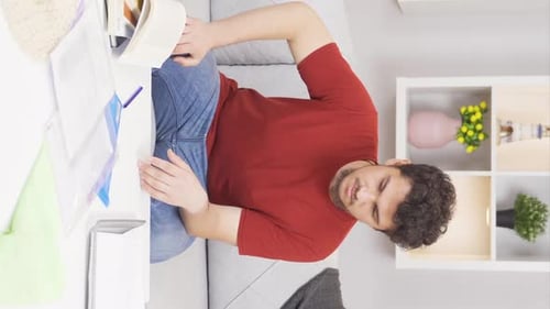 Man Experiencing Stomach, Wrist, and Arm Pain on Couch