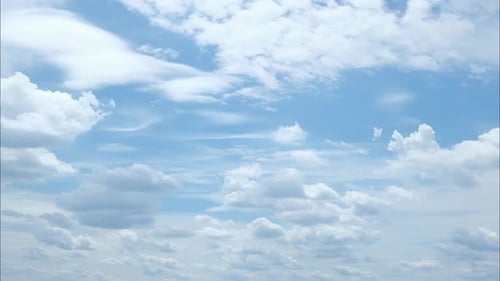 Fluffy Clouds Drifting across a Radiant Blue Sky