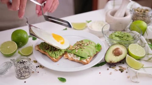 Preparing Toast with Avocado and Egg for Breakfast