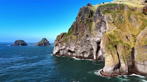 Beautiful cliffs covered with moss towering above the waterscape of the Atlantic Ocean