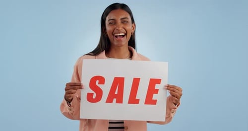 Happy woman, billboard and sale sign for discount, price or shopping deal against a studio