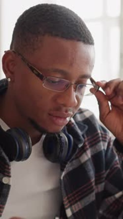 Student in Glasses Uses Computer in Library