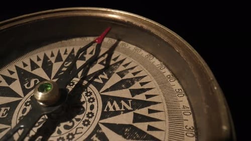 Travel Planning Navigation Concept Vintage Magnetic Compass with a a Rotating Arrow Close Up on a
