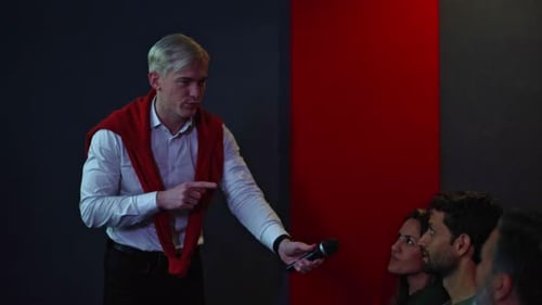Professional Man Giving Mic to Audience at Conference
