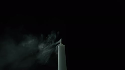 Closeup Wind Stopping Candle Flame in Darkness Wax Taper Fire Snuffed on Black
