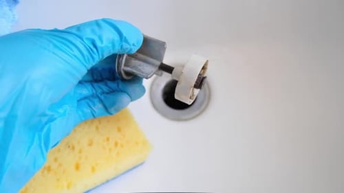 Gloved Hand Cleaning Sink With Cleaning Sponge