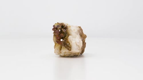 Close view of Vanadinite on Barite mineral. Rotating front to back.