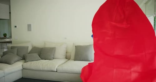 A carefree happy smiling father and daughter dressed as superheroes are having fun to run and jump