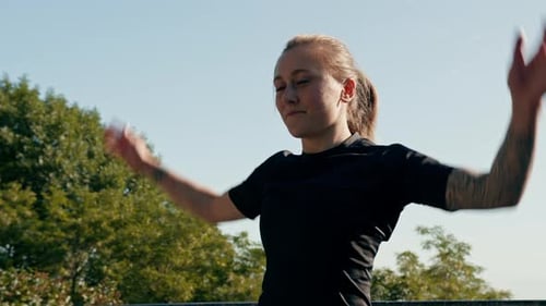 Woman Doing Jumping Jacks Outdoors