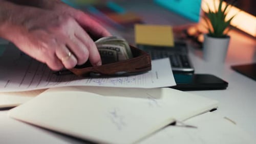 Man Counting Money into Brown Leather Wallet