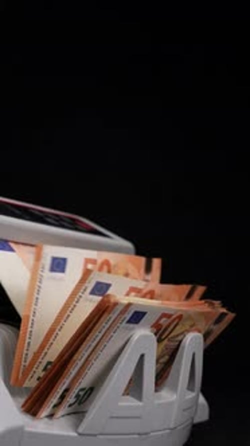 Money Counter Sorting Euro Bills in Close Up