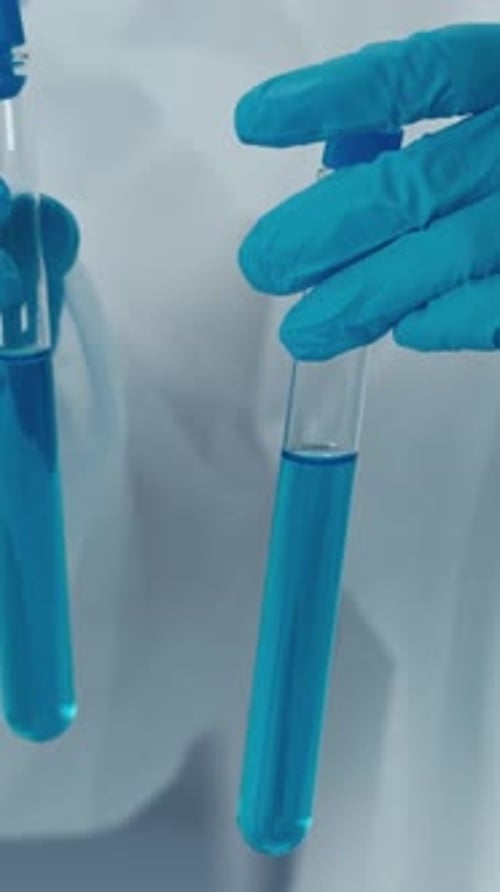 Scientist Pours Blue Liquid in Laboratory