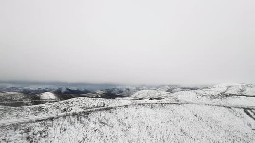 Snow-covered mountains provide a serene and peaceful landscape during winter season in remote area.