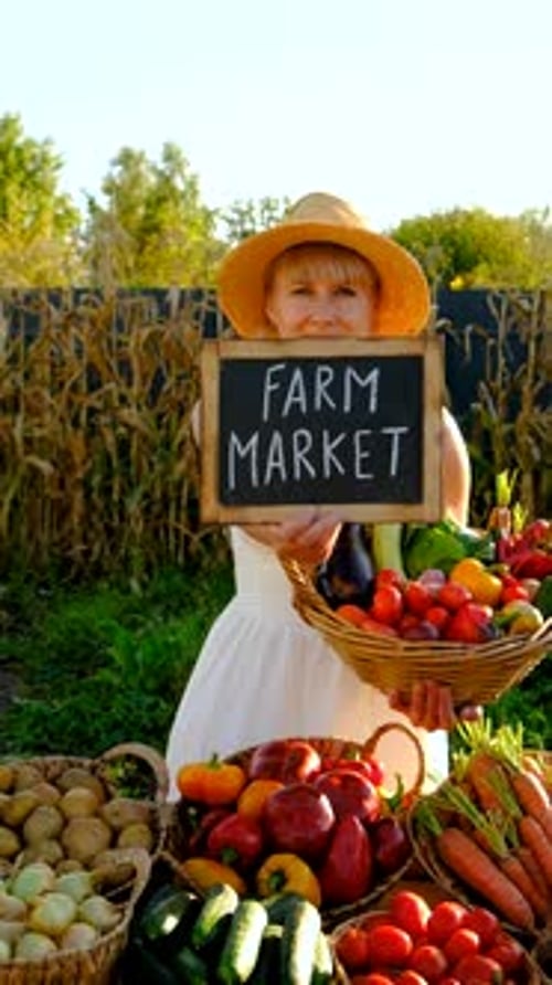 Woman at a Farmers Market with Vegetables Selective Focus