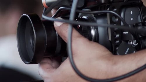 Hand Adjusting Lens on Professional Video Camera