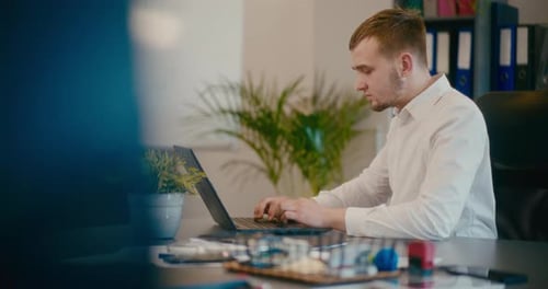 Businessman Working on Laptop in Office