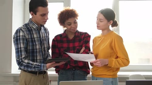 Young Adults Teamwork in Modern Office with Tablet