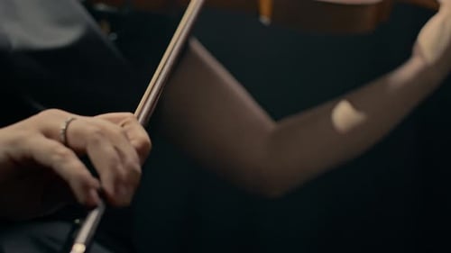 Woman Playing Violin Close Up on Black Background