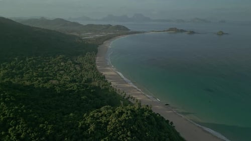 Forest, beach, sea and hilly islands in Philippines, forward aerial