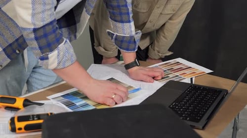 Two Men Discuss Issues Pointing with a Pen at the Laptop Screen