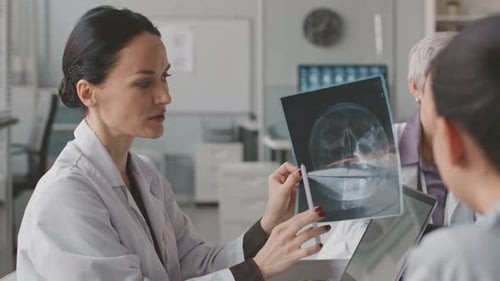 Medical Professionals Discussing Patient X-Ray Results