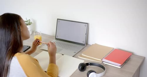 Woman Working at Desk with Laptop and Juice